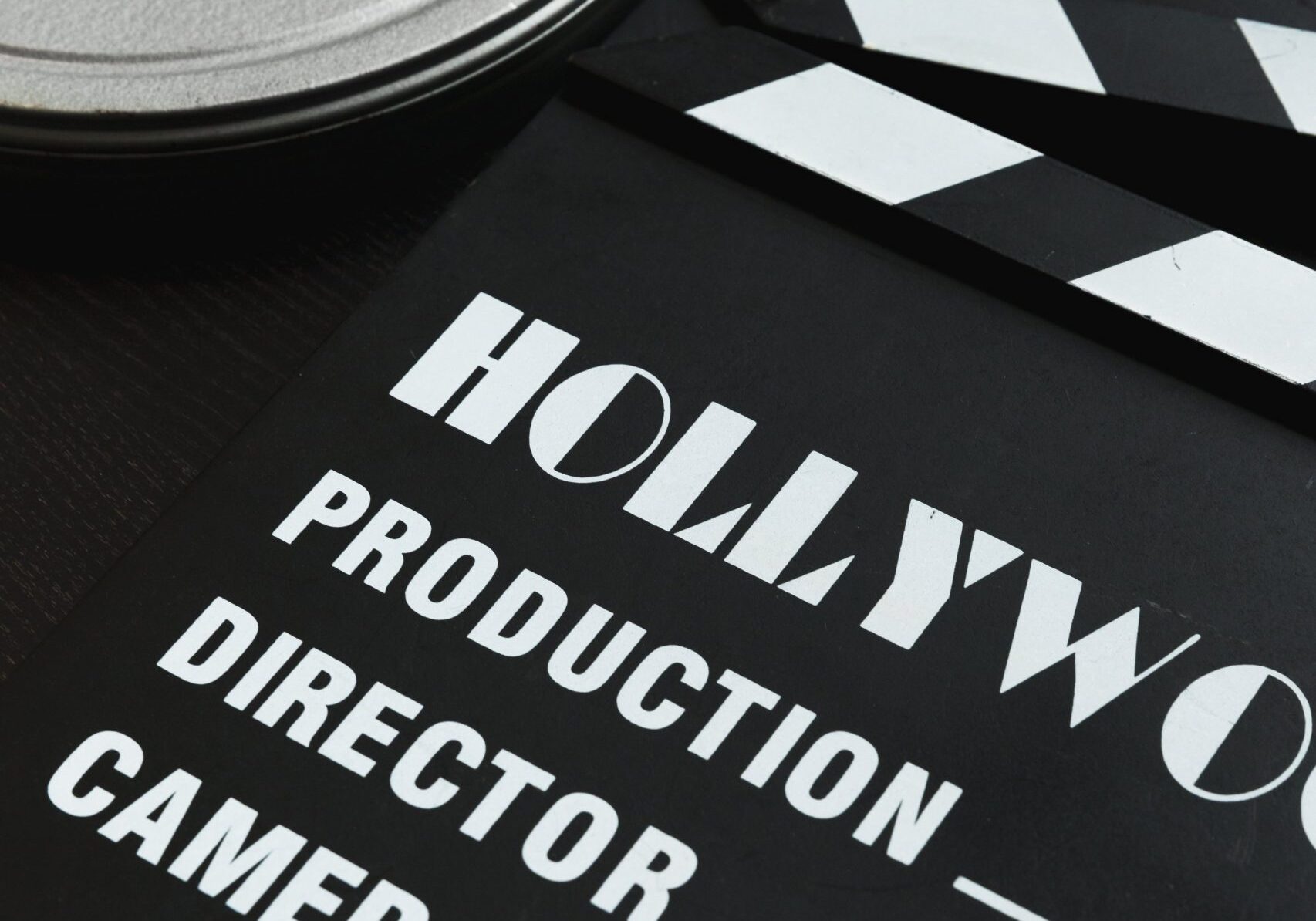 a-silver-film-reel-canister-and-a-movie-clapper-board